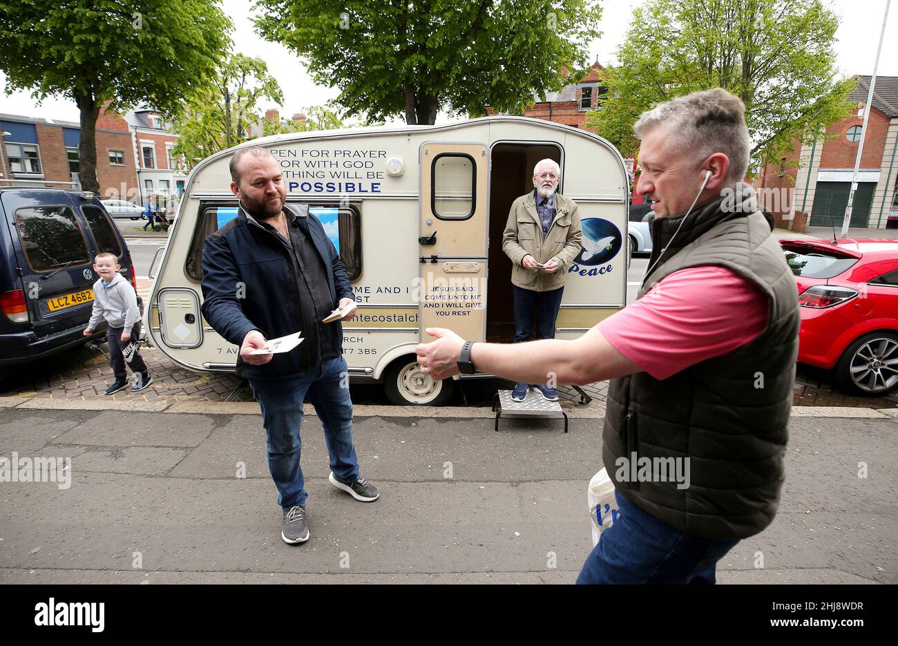 A religious Christian pastor pictured conducting his street evangelism with his caravan on the Ormeau Road in south Belfast, Northern Ireland. Stock Photo