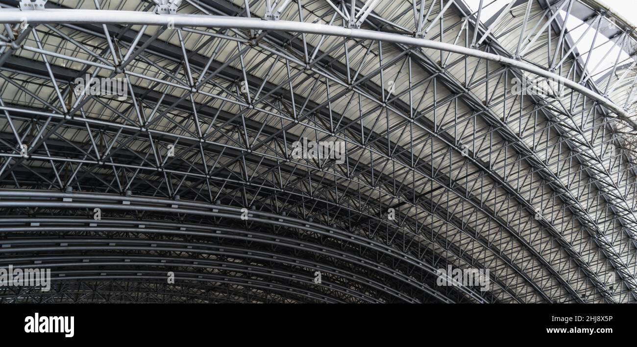 Urban geometry. Roof vault of the amphitheater from metal structures. Horizontal photo. Stock Photo