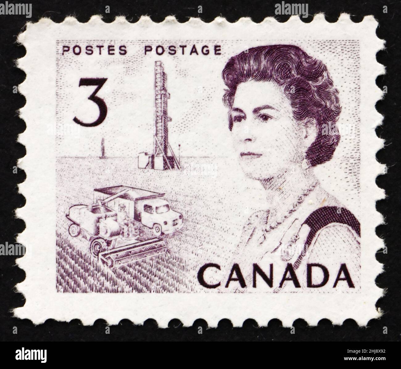 CANADA - CIRCA 1967: a stamp printed in the Canada shows Combine and Oil Rig, Prairie Region, Queen Elizabeth II, circa 1967 Stock Photo