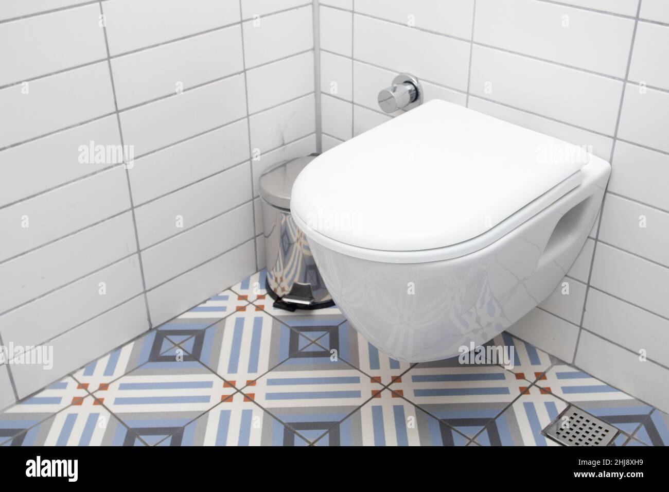 Floating toilet. Mounted toilet bowl in clean modern bathroom Stock