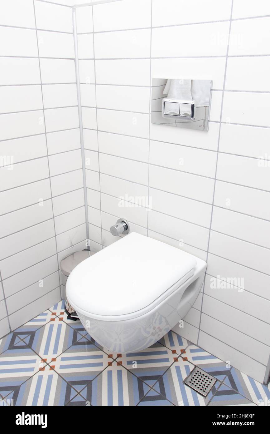 Floating toilet. Mounted toilet bowl in clean modern bathroom Stock