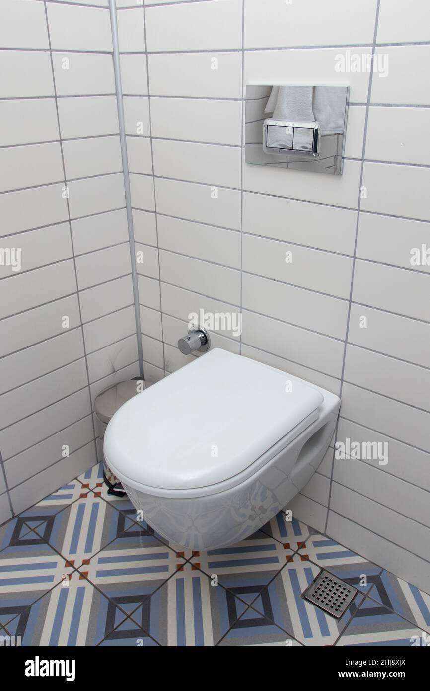 Floating toilet. Mounted toilet bowl in clean modern bathroom Stock