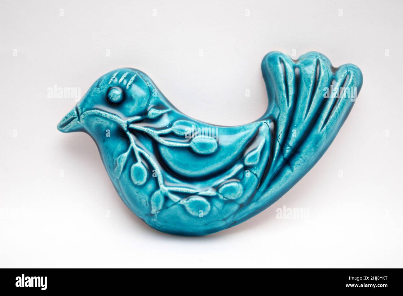 A figurine of a blue ceramic bird. The blue bird is a symbol of happiness Stock Photo