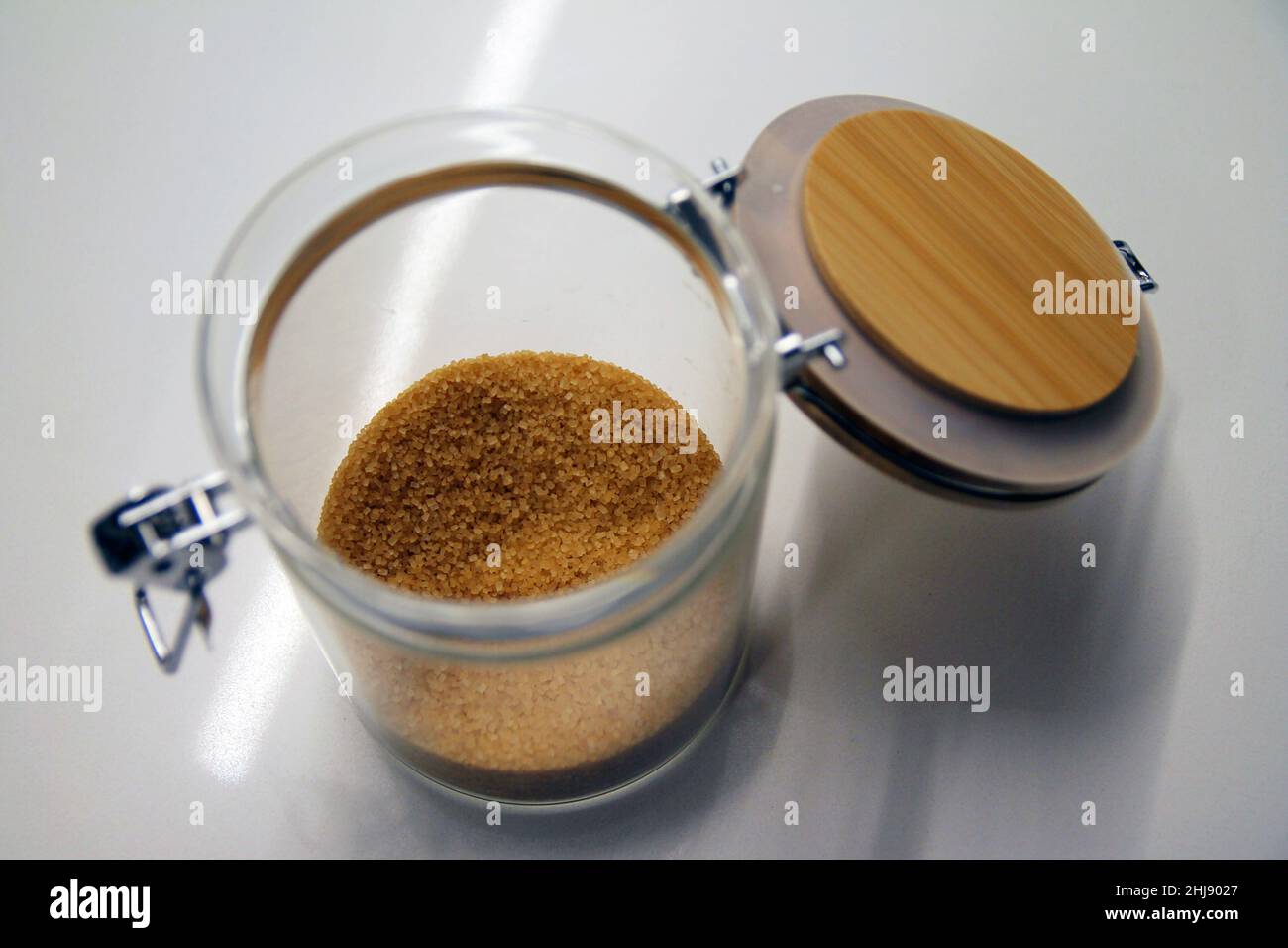 Close up of a isolated glass and wood cane sugar jar with its lock Stock Photo