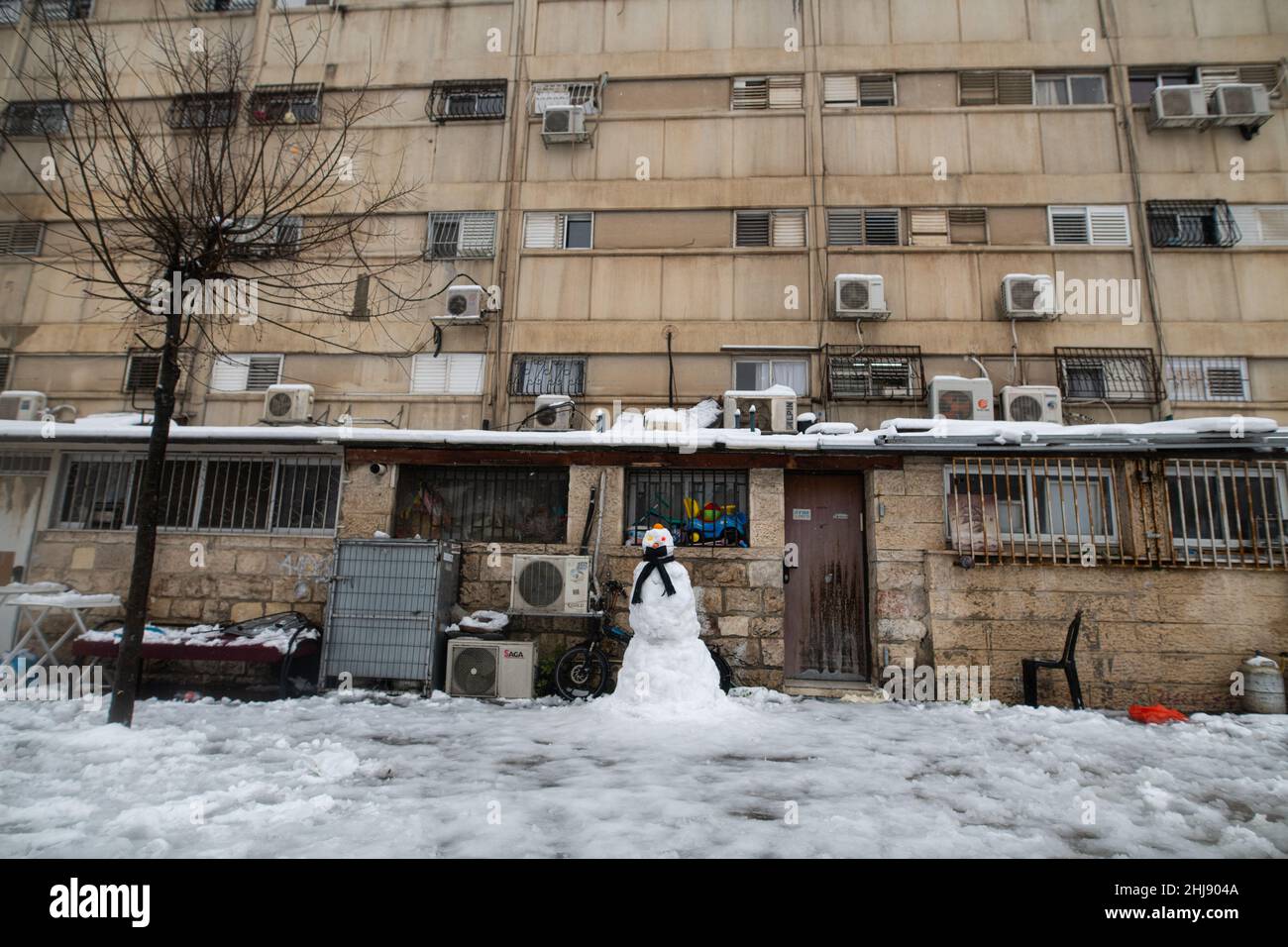 Snowman with corona mask at the entrance to a Jewish Orthodox house. Jerusalem, Israel. Jan 27th 2022. ( Credit: Matan Golan/Alamy Live News Stock Photo