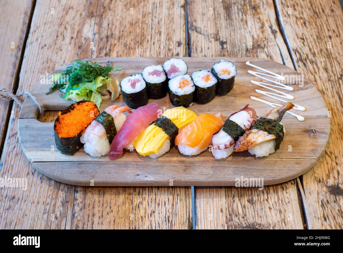 Delux sushi platter with salmon and tuna rolled nori, ebi, unago and salmon nigiri & tobiko gunkan Stock Photo