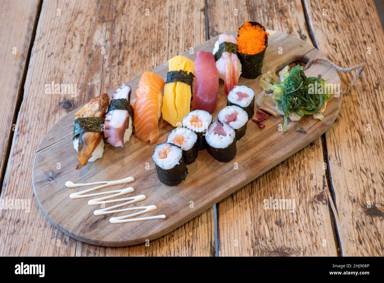 Delux sushi platter with salmon and tuna rolled nori, ebi, unago and salmon nigiri & tobiko gunkan Stock Photo
