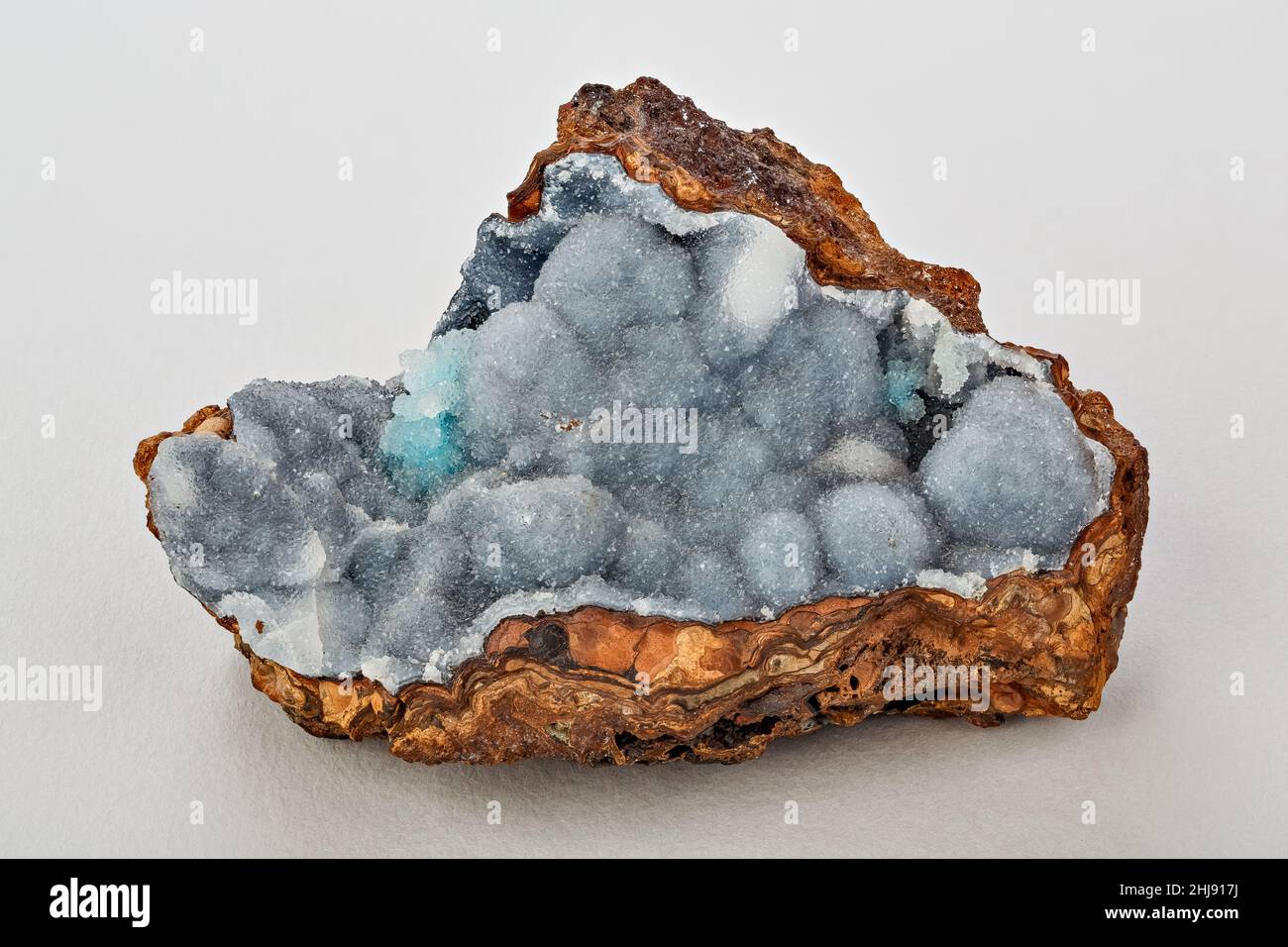 Encrustation of quartz crystals on a base of limonite, hidden in a geode Stock Photo