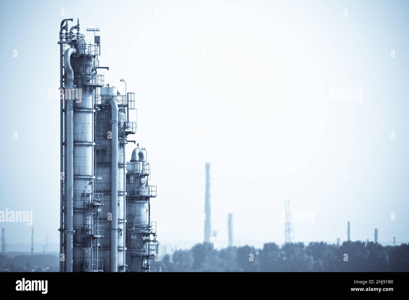 Photoartistic representation of a chemical plant with three distillation columns. Stock Photo