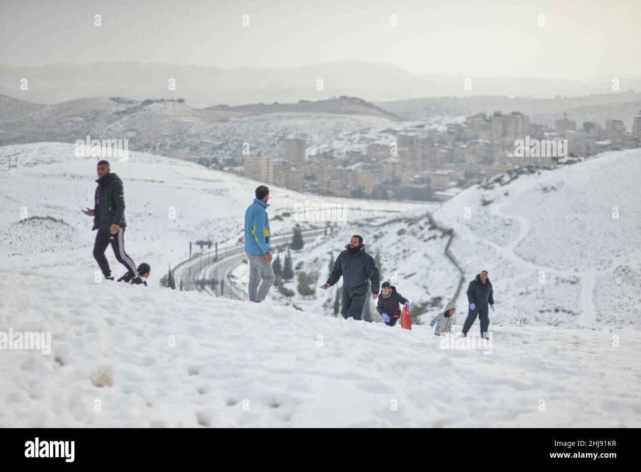 Israeli and Palestinian Families play in the snow on Mount Scopus. Jerusalem, Israel. Jan 27th 2022. ( Credit: Matan Golan/Alamy Live News Stock Photo