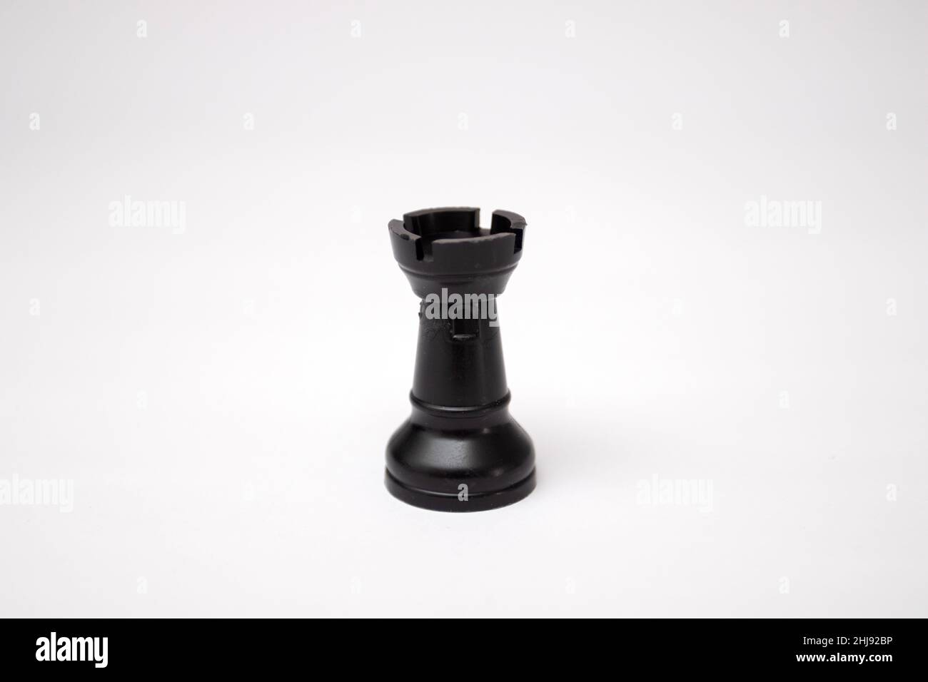 Black rook chess piece on a white background Stock Photo - Alamy