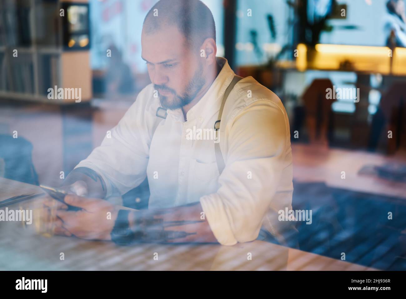 Serious man typing message on smartphone Stock Photo