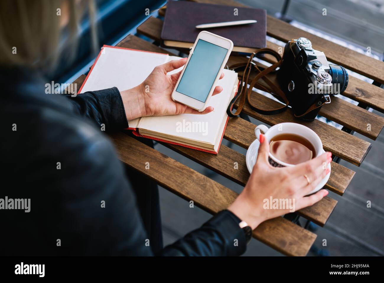 Unrecognizable woman using phone in cafe Stock Photo