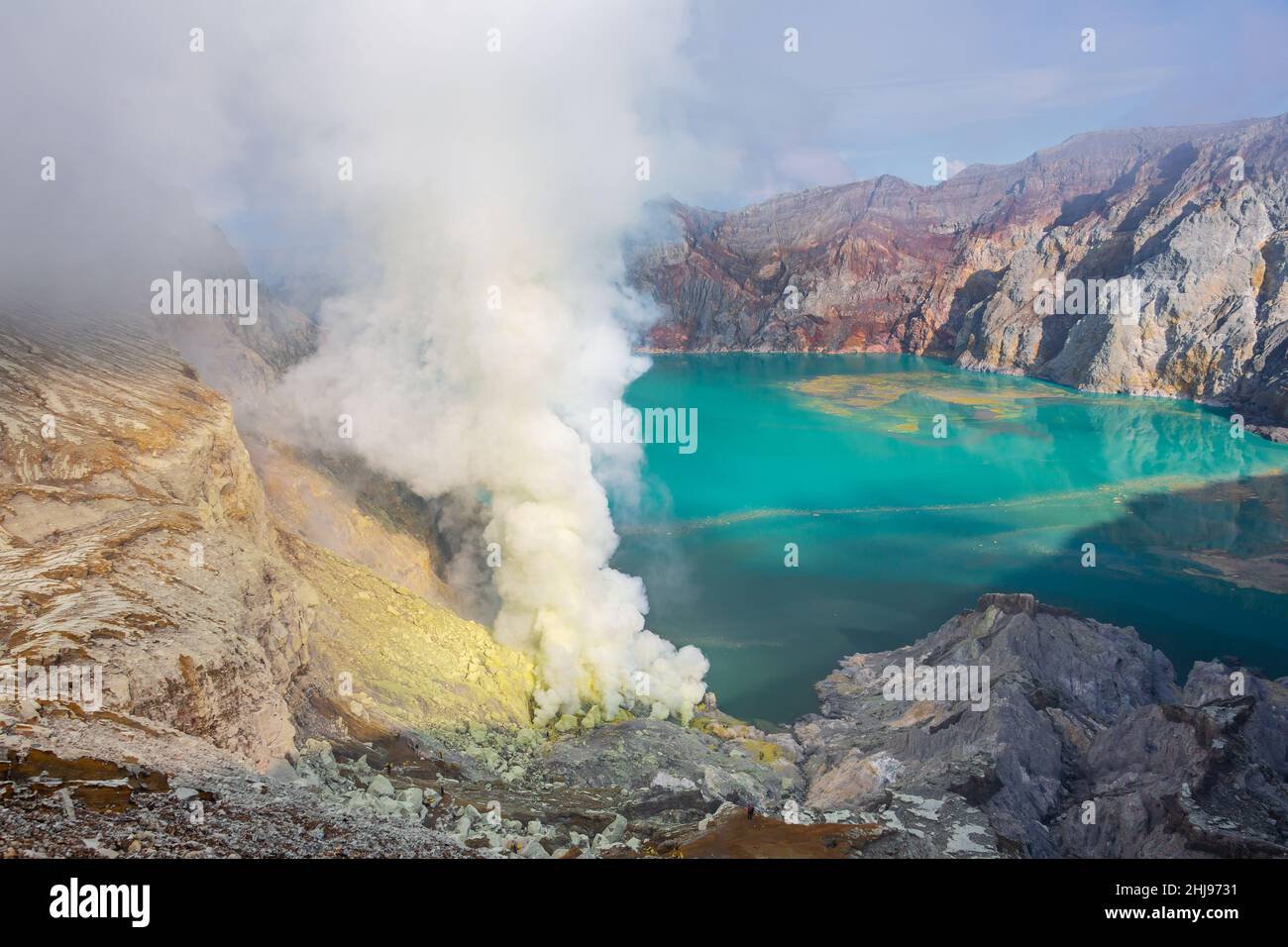 Sulfurous smokes from the volcano are the source of the sulfur mine. The water of the lake is highly aciduous. Stock Photo
