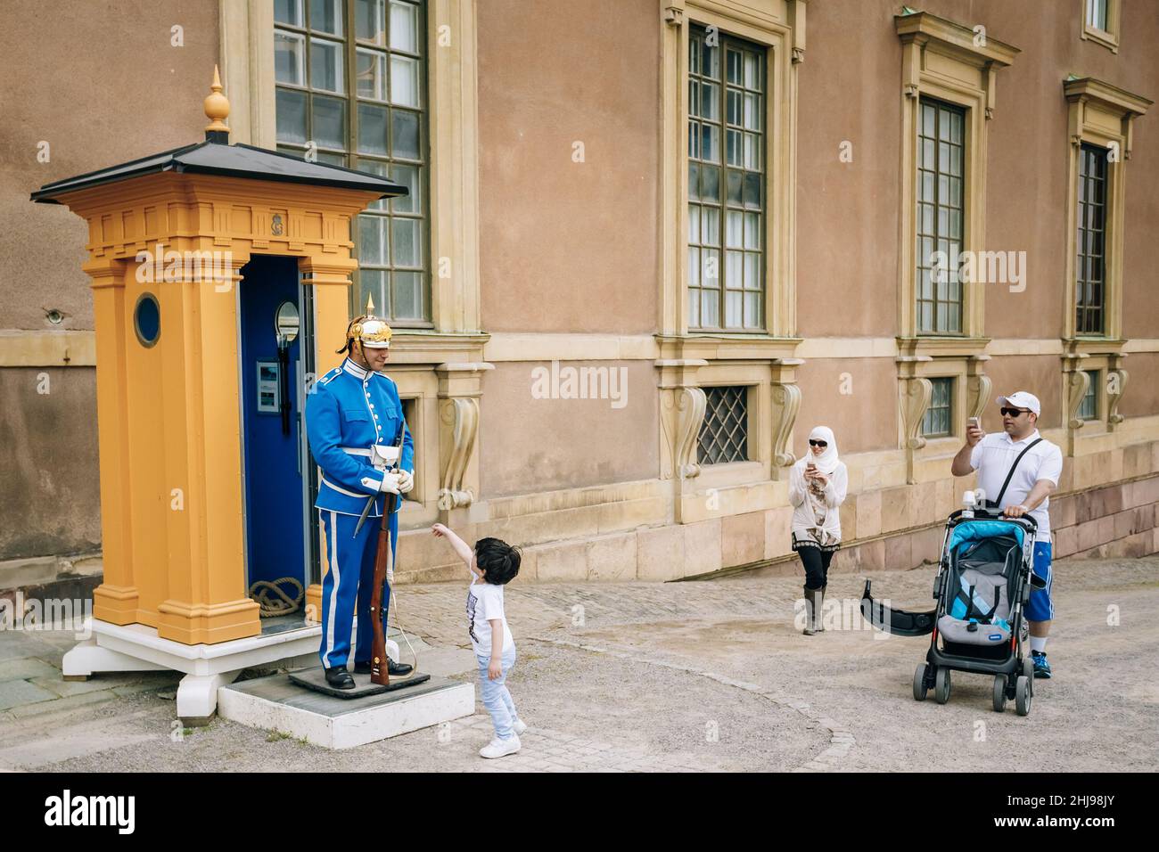 Tourists visit and photograph the guard of honor at the Royal palace in Gamla Stan, where king Carl XVI Gustaf has his working office. Stock Photo