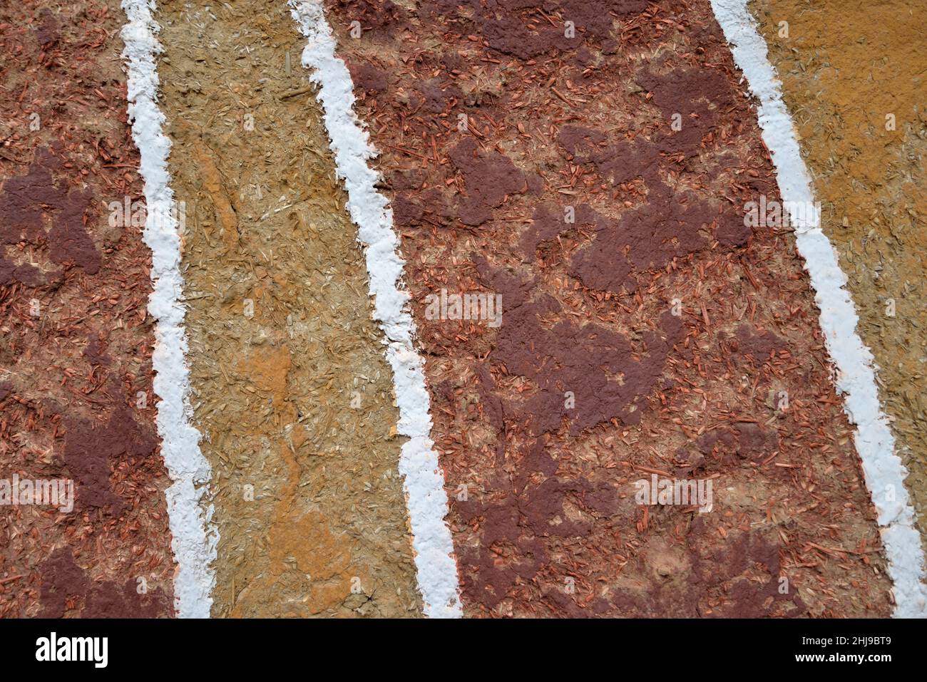 Brown and yellow house wall background made of clay and straw with white stripes Stock Photo