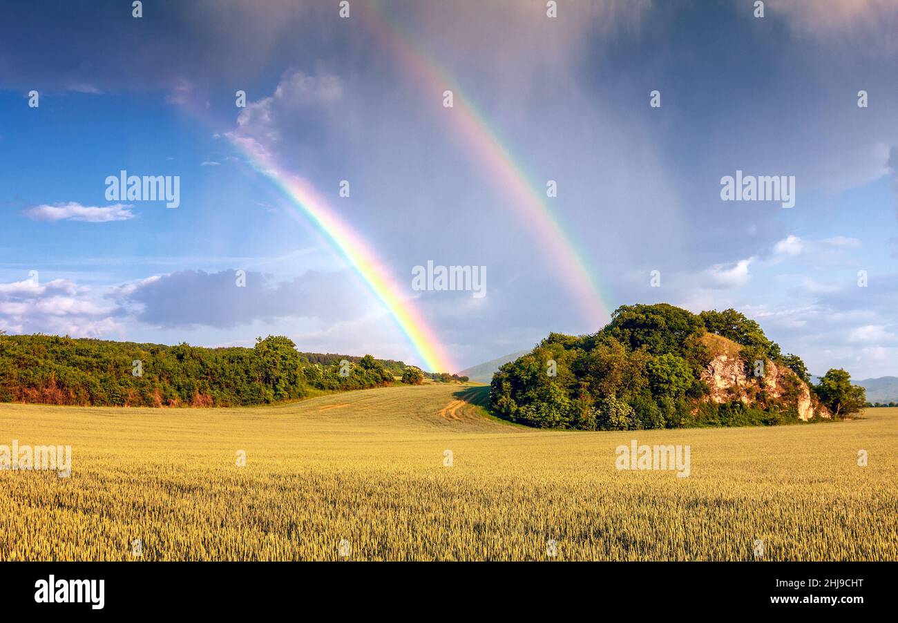 Landscape after a storm with dramatic sky and rainbow Stock Photo - Alamy