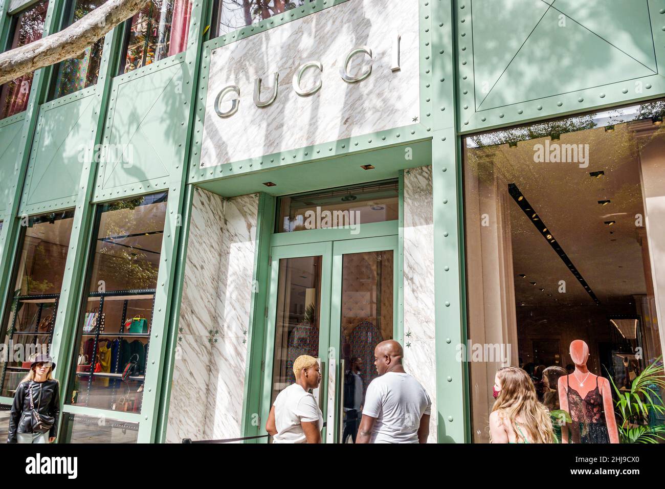 Miami Florida Design District shopping shoppers Gucci luxury fashion  designer clothing outside exterior entrance sign store Covid-19 pandemic  occupanc Stock Photo - Alamy