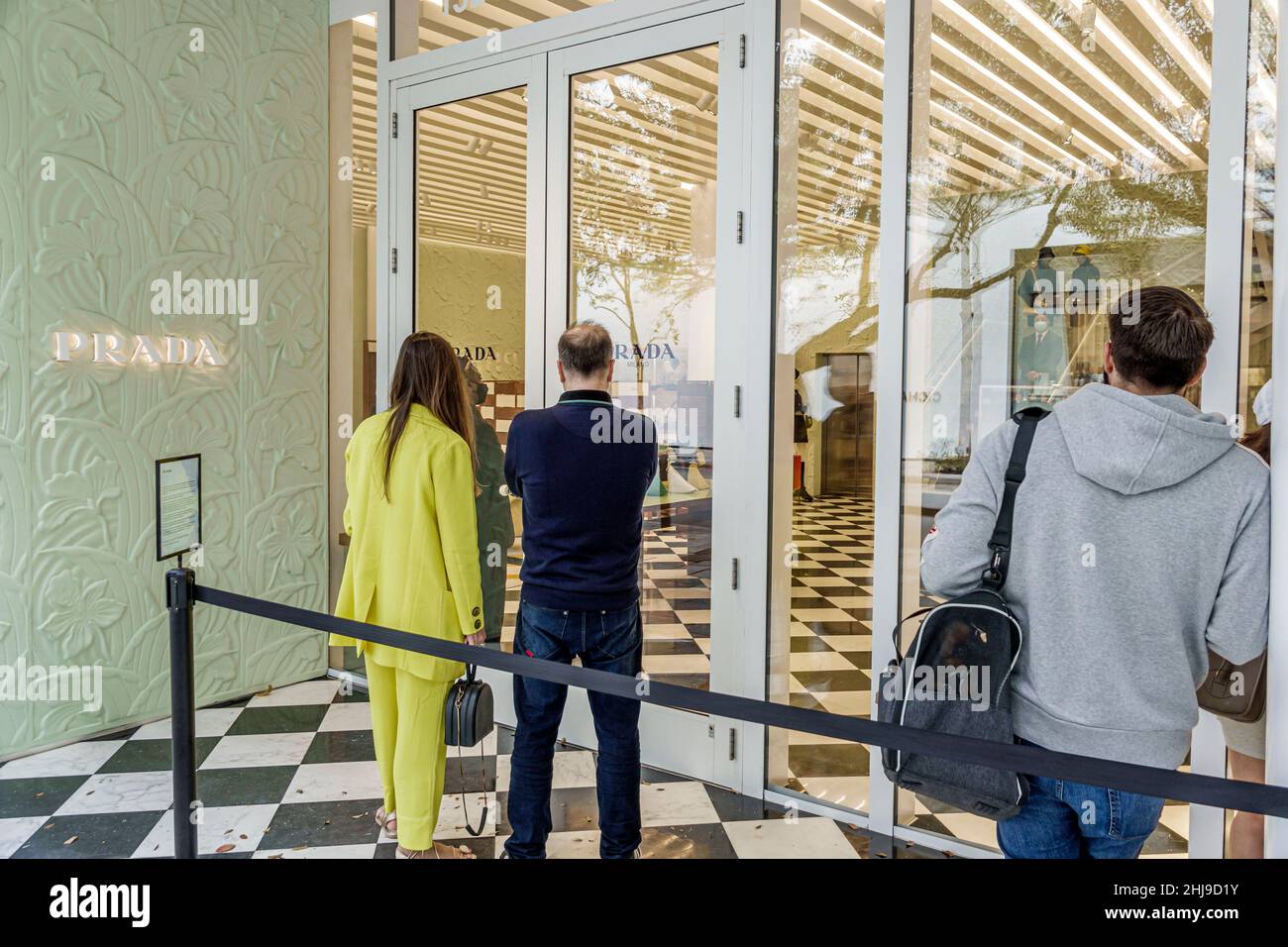 Miami Florida Design District shopping shoppers Prada Italian luxury  fashion designer line queue entrance exterior outside store Covid-19  pandemic occ Stock Photo - Alamy