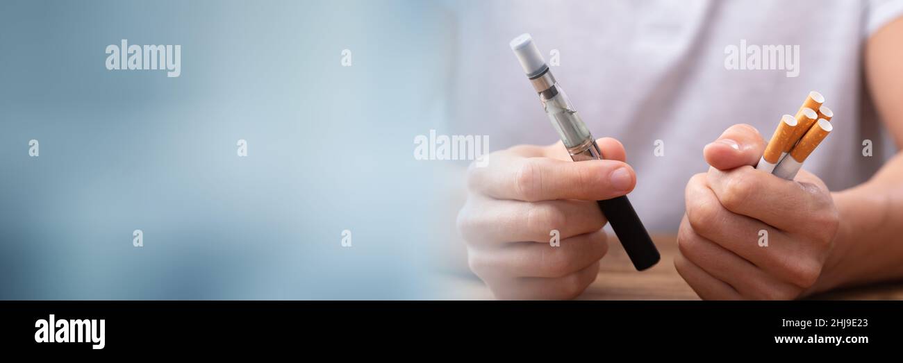 Hand Holding E Cigarette And Vape Cigar Stock Photo