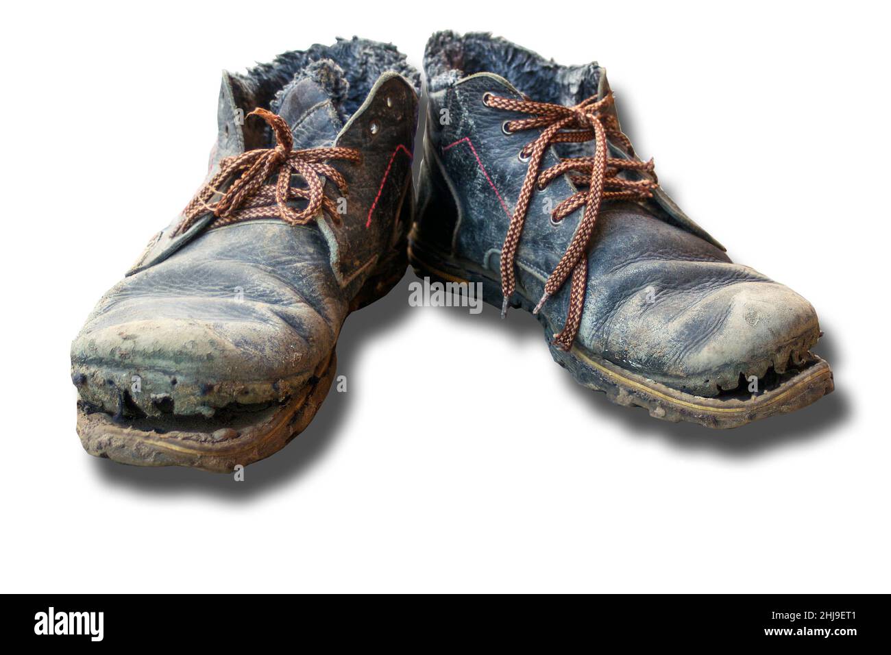 Isolated pair of dirty boots. Old worn dark blue leather shoes with