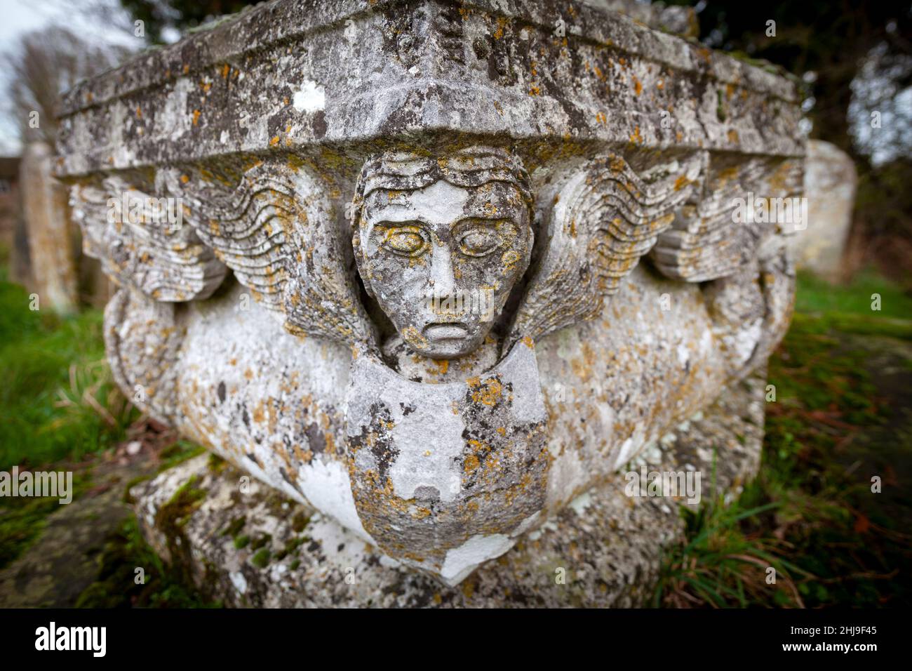 Carved stone coffin headstone with angel heads at St Peter and St Paul Church, Pettistree, Suffolk,UK Stock Photo