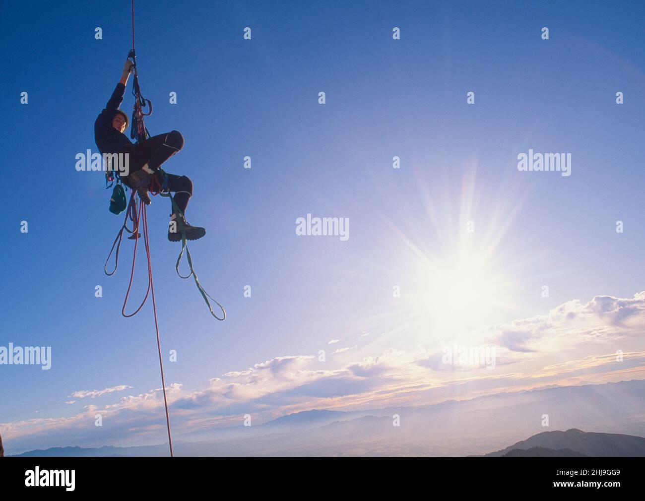 Single female climber uses ascenders to climb a rope on the east face of Baboquivari Peak in