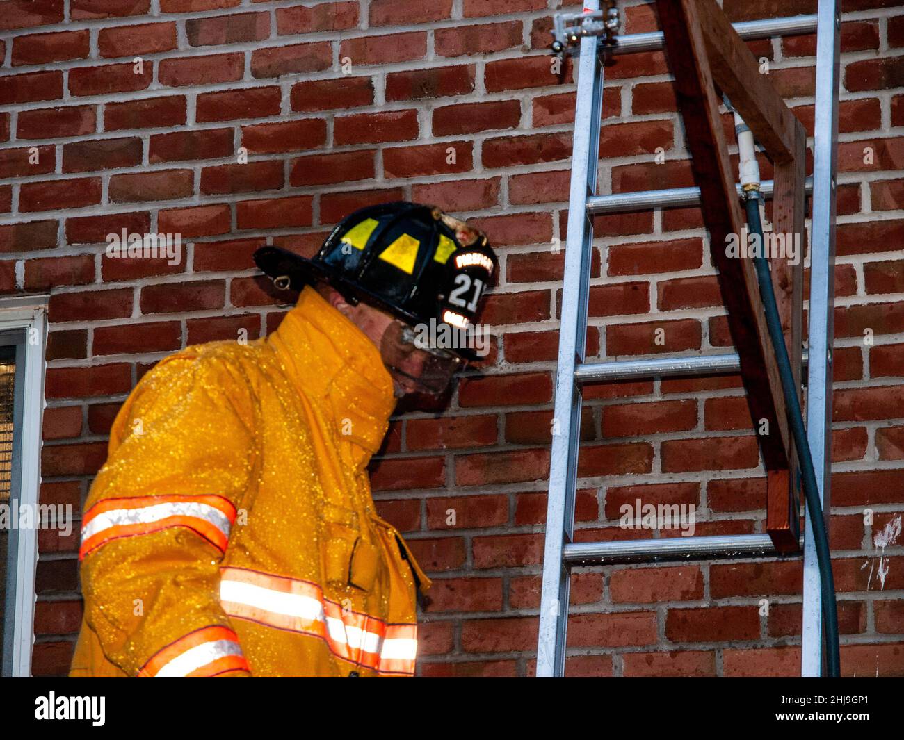 Firefighters drill on sprinkler system in turnout gear Stock Photo Alamy