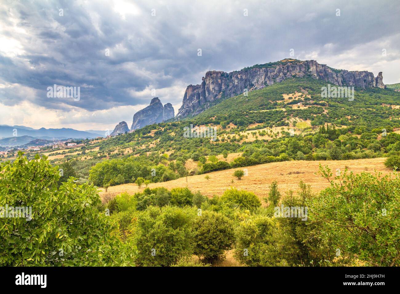 The Meteora with dramatic overcast sky, a rock formation hosting built complexes of monasteries,  Greece, Europe. Stock Photo