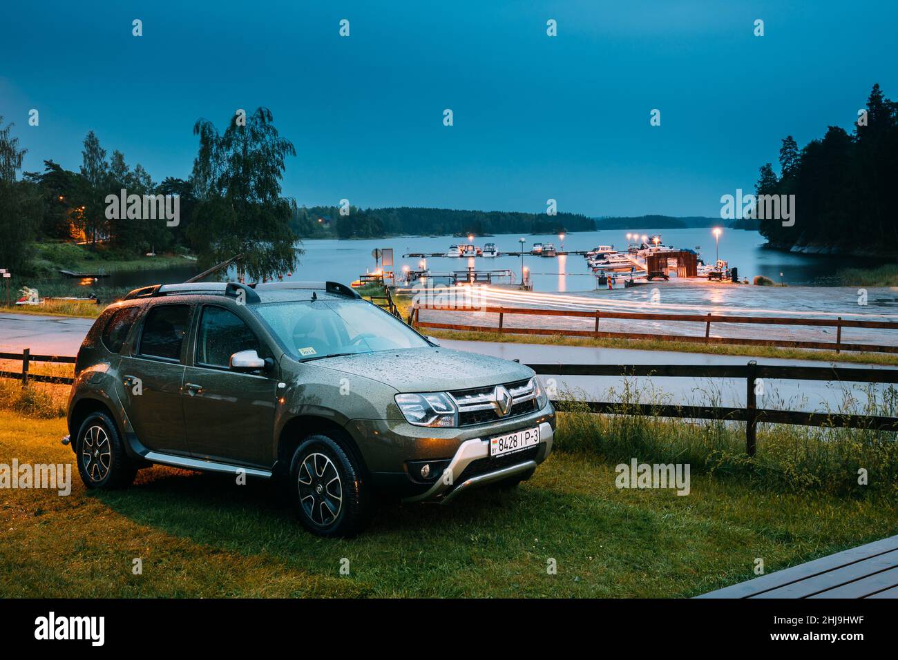 Tocksfors, Sweden. Car Renault Duster SUV Parked Near Lake Or River Landscape In Swedish Countryside Landscape. Summer Evening Night Stock Photo