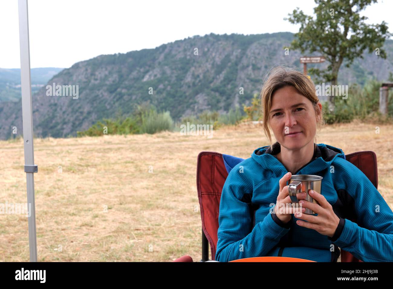 Mature Female Having Breakfast In Camping Site Stock Photo
