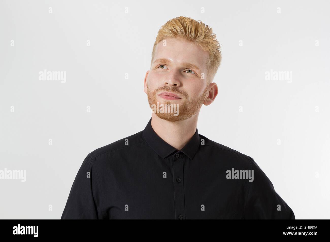 Young entrepreneur Generate Business Ideas. Close up of thinking Man in black shirt isolated with copy space. Self improvement and serious male face. Stock Photo