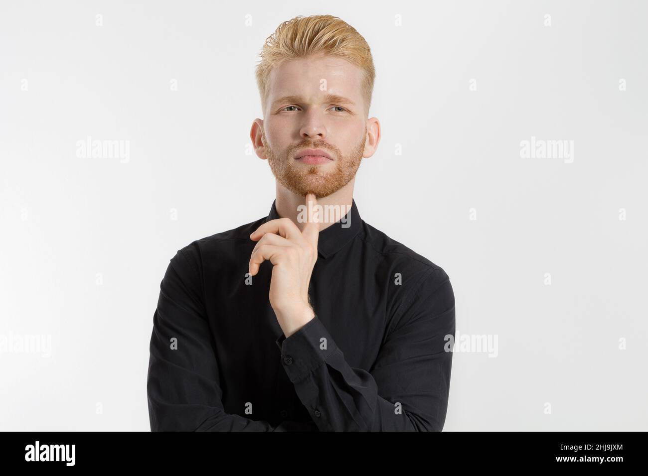 Young entrepreneur Generate Business Ideas. Close up of thinking Man in black shirt isolated with copy space. Self improvement and serious male face. Stock Photo