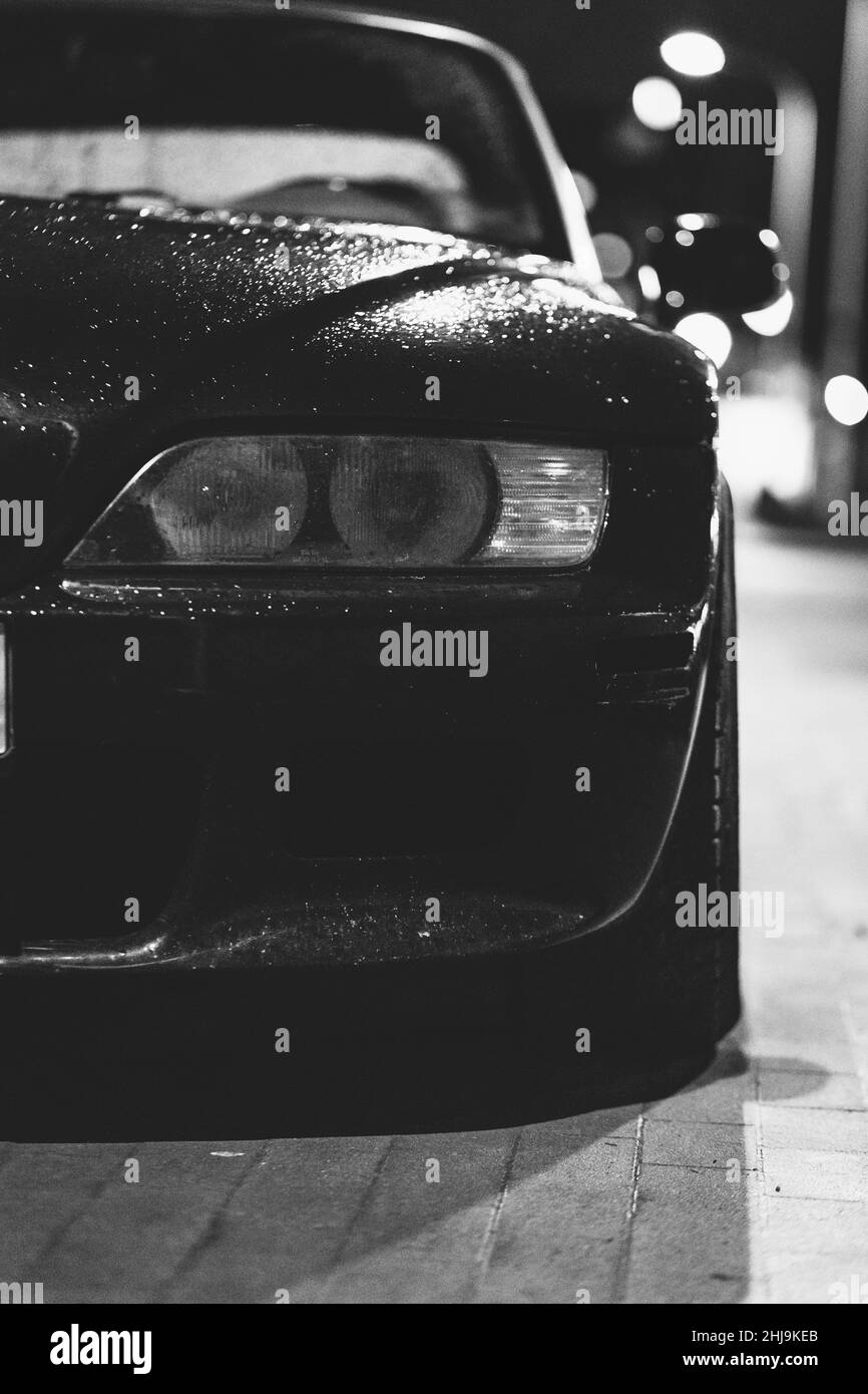 Quarter view on front of a car with visible headlight and blurred background Stock Photo