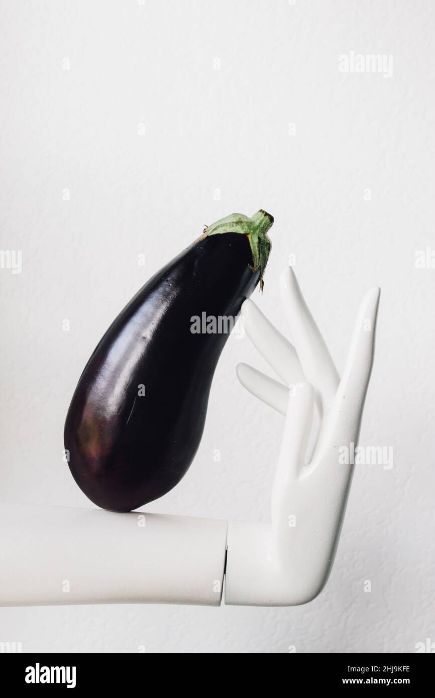 eggplant modeled by white mannequin hand Stock Photo