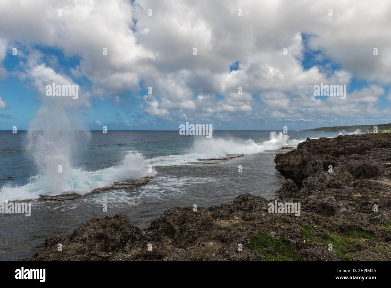Blowholes shoot skywards along the Tonganese coast as the tide rolls in. Stock Photo