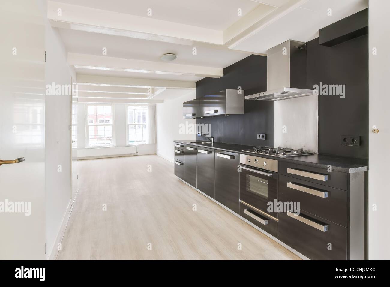 Interior of a bright empty room with modern kitchen appliances with ...
