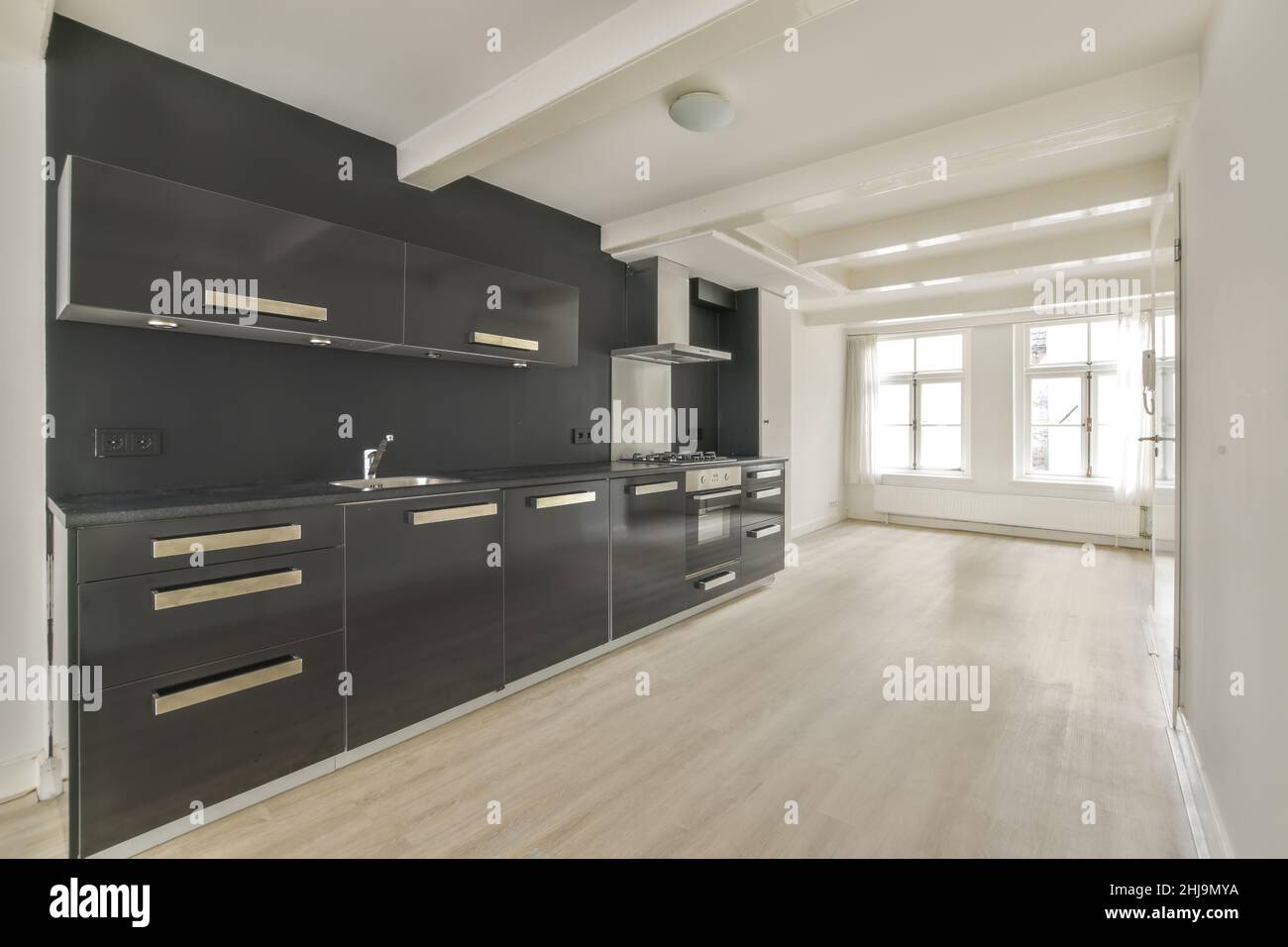 Interior of a bright empty room with modern kitchen appliances with ...