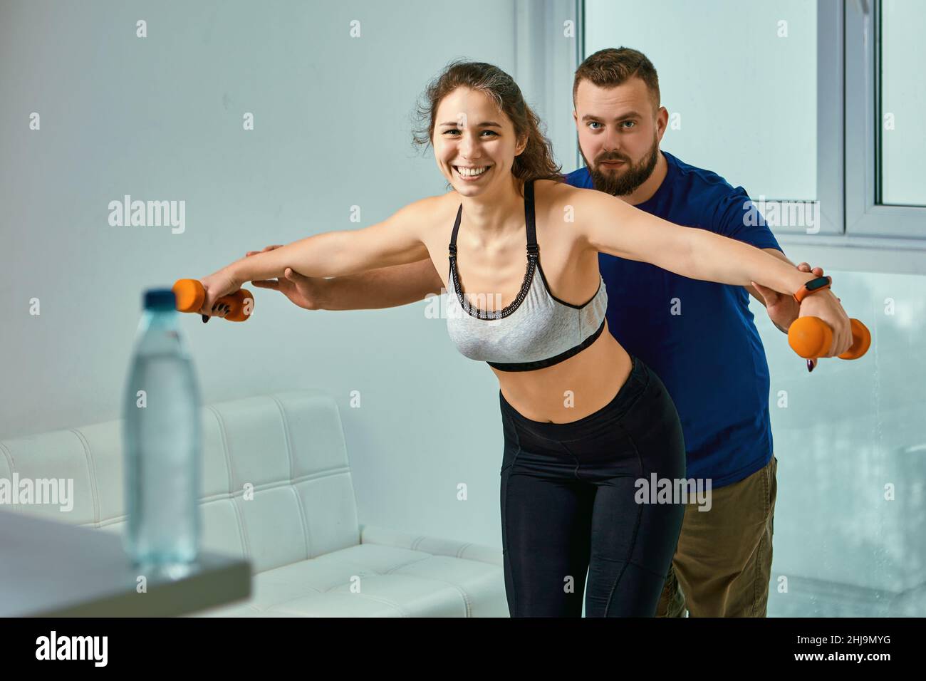 Smiling female fitness trainer hi-res stock photography and images - Alamy