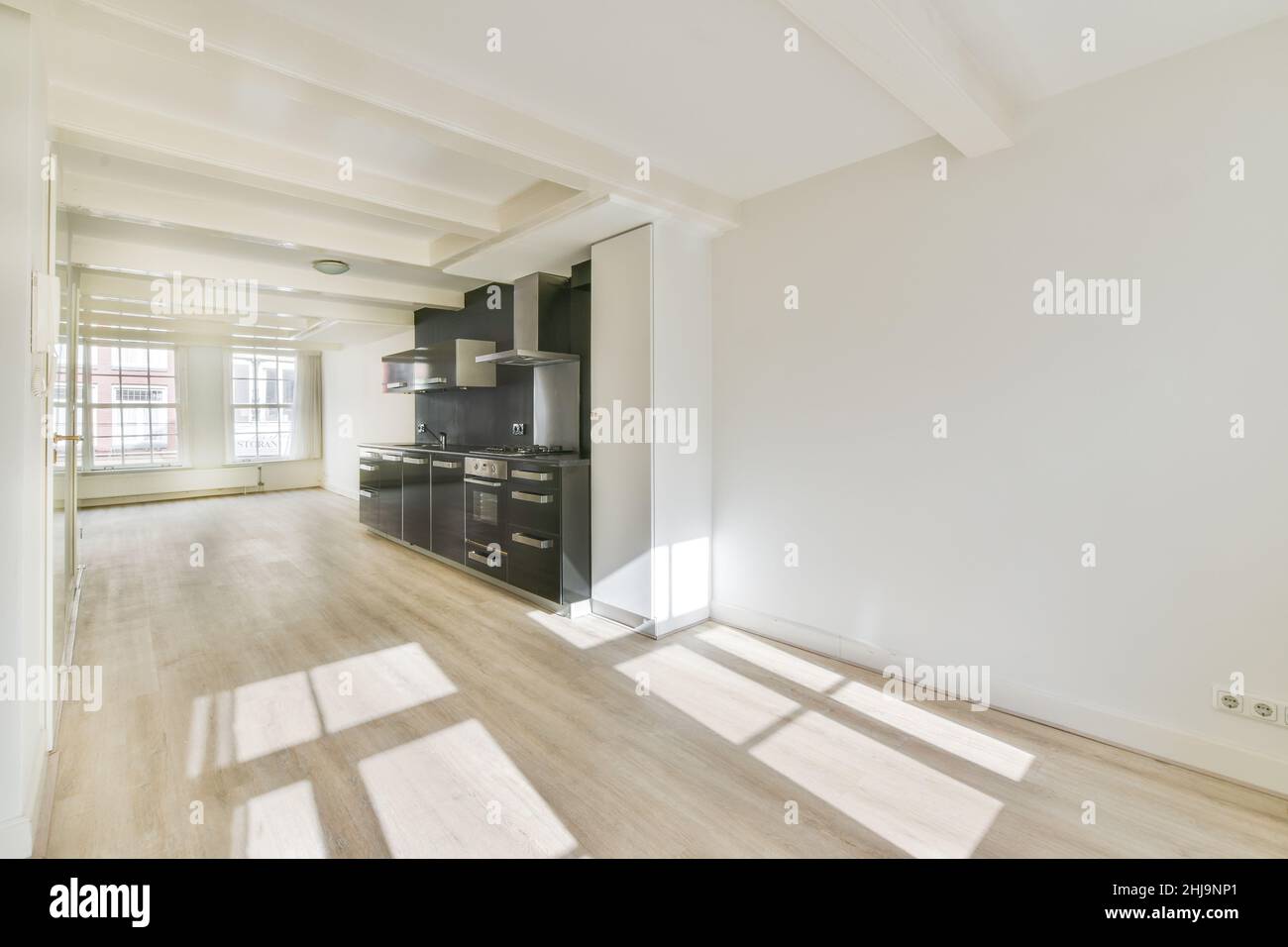 Interior of a bright empty room with modern kitchen appliances with ...