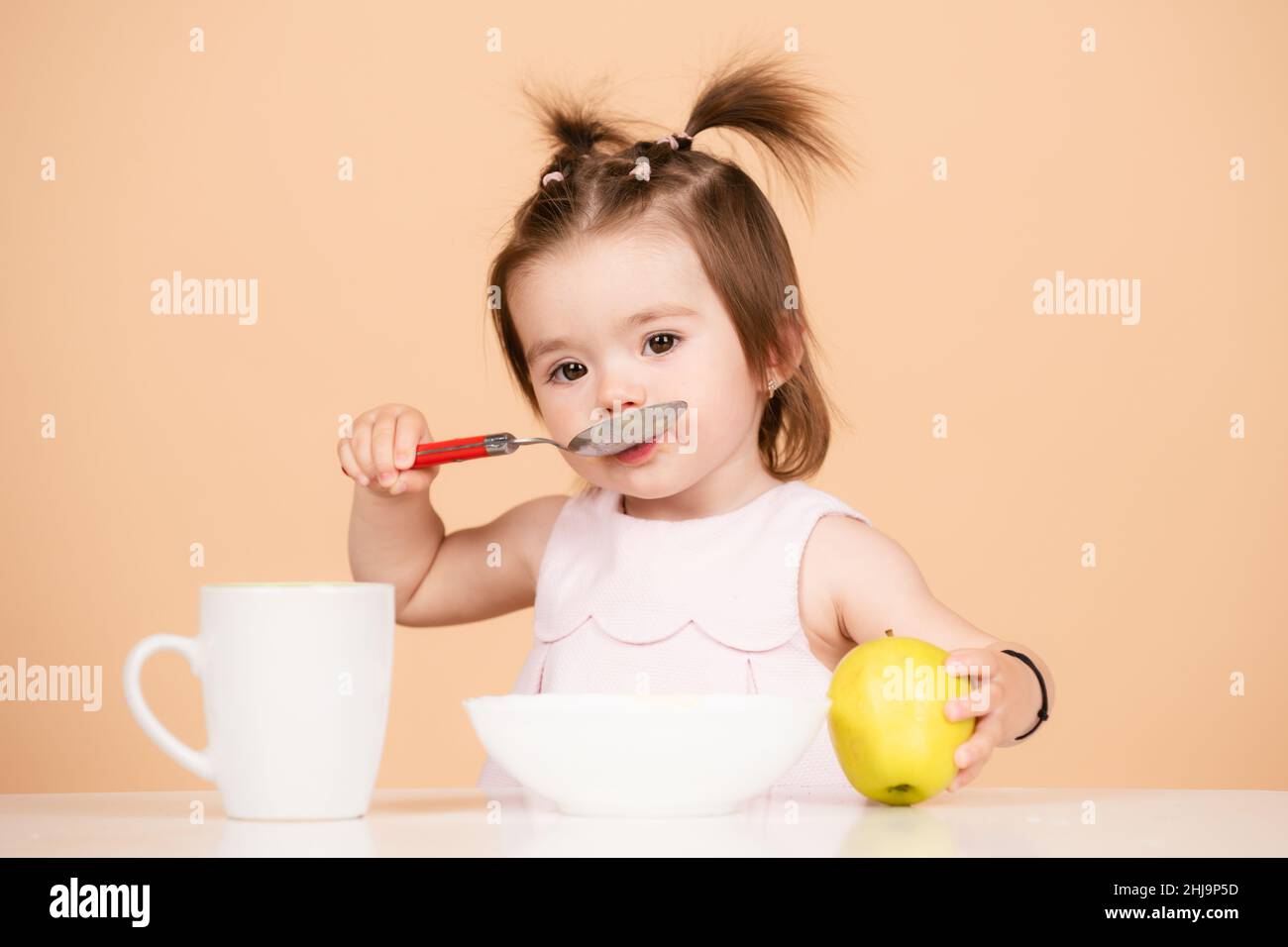 Cute baby food, babies eating. Kid eating healthy food with a spoon at ...