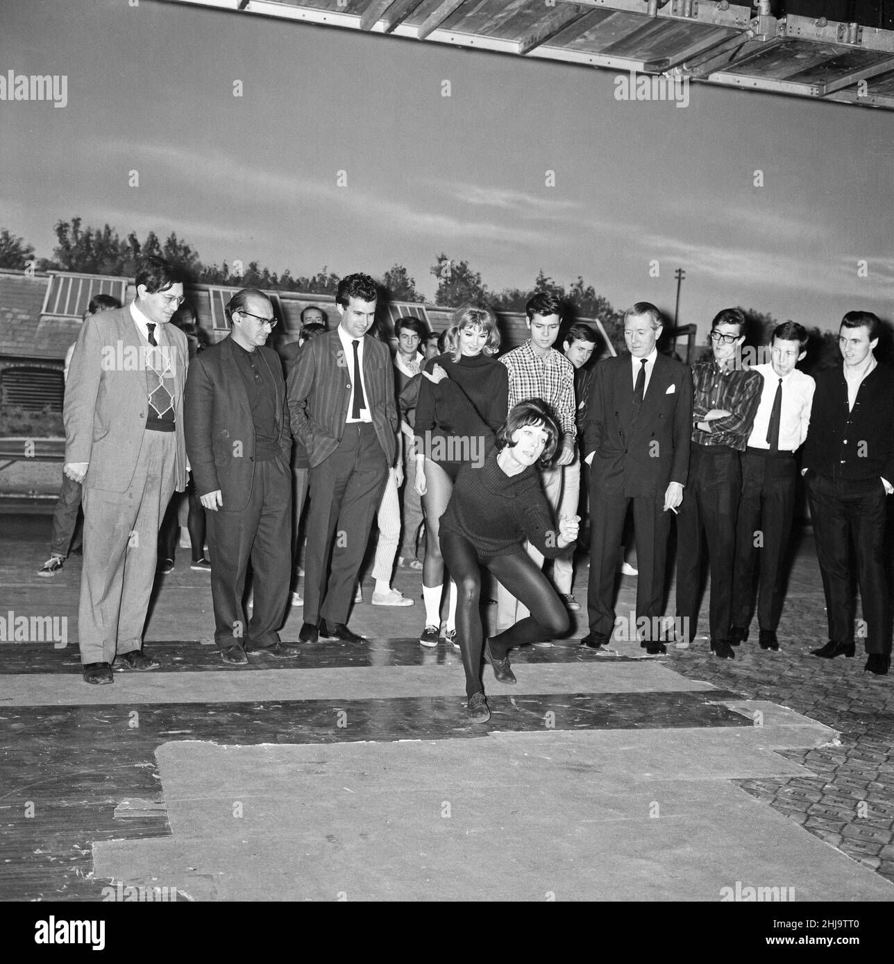 Gillian Lynne, the choreographer for the film "Wonderful Life" leads the whole company in some dance routines. L-R Peter Myers, Ronnie Cass, Sidney Furie, Susan Hampshire, Cliff Richard, Ken Harper, Hank Marvin, Brian Bennett and Bruce Welch. 6th November 1963. Stock Photo