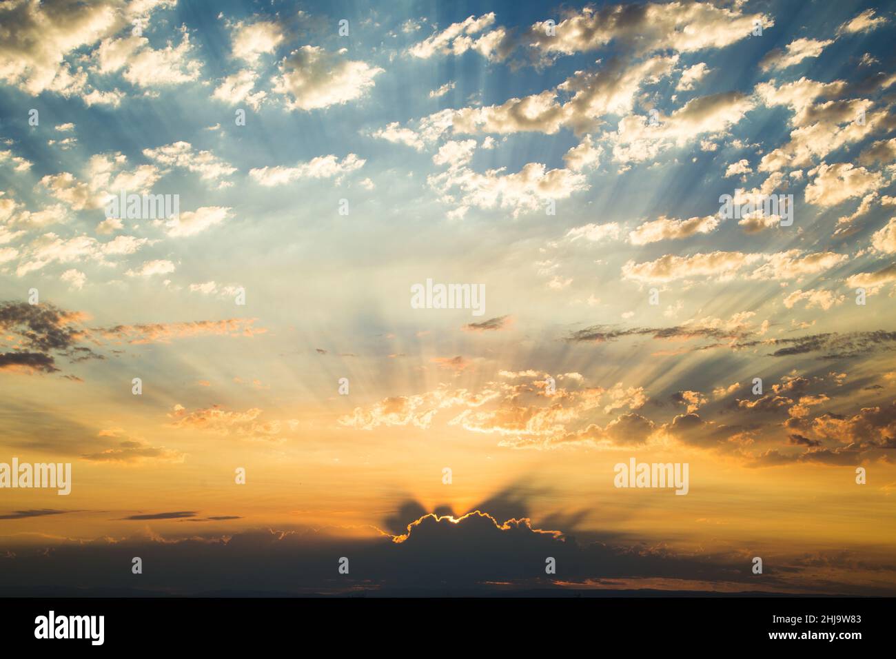 Morning sunrise with golden god sunlight rays and dramatic clouds Stock ...