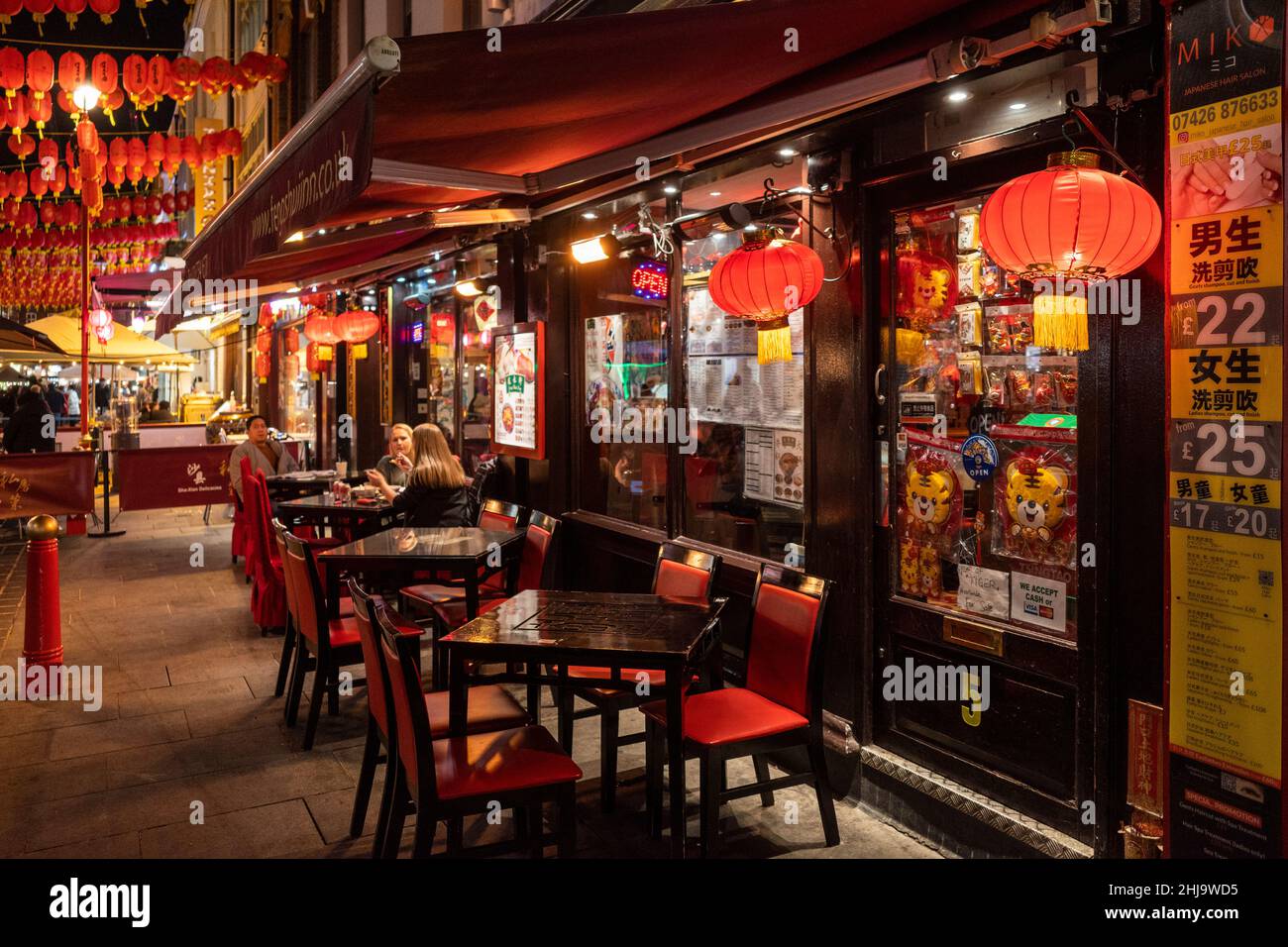 London UK. 27 January 2022. Outdoor dining tables outside a restaurant at night in Chinatown ahead of Chinese New Year. The Year of the Tiger officially begins on 1 February. Festivities in