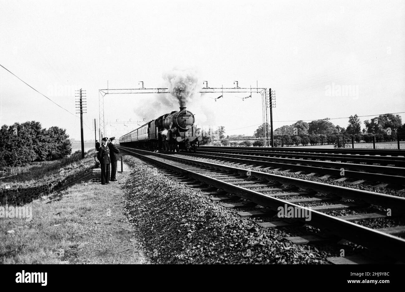 1963 Great Train Robbery was the robbery of ¿.6 million from a Royal Mail train heading from Glasgow to London on the West Coast Main Line in the early hours of 8th August 1963, at Bridego Railway Bridge, Ledburn, near Mentmore in Buckinghamshire, England. After tampering with the lineside signals in order to bring the train to a halt, a gang attacked the train.  Our Picture Shows ... Passenger Train passing by on West Coast Main Line. Stock Photo