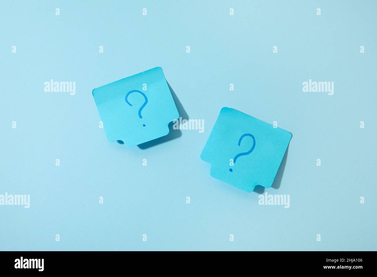 Sticky notes with question marks on blue background Stock Photo