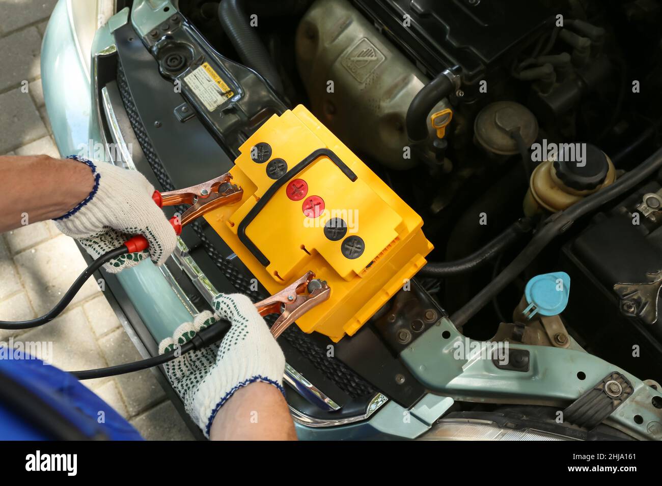 Male mechanic charging car battery Stock Photo Alamy