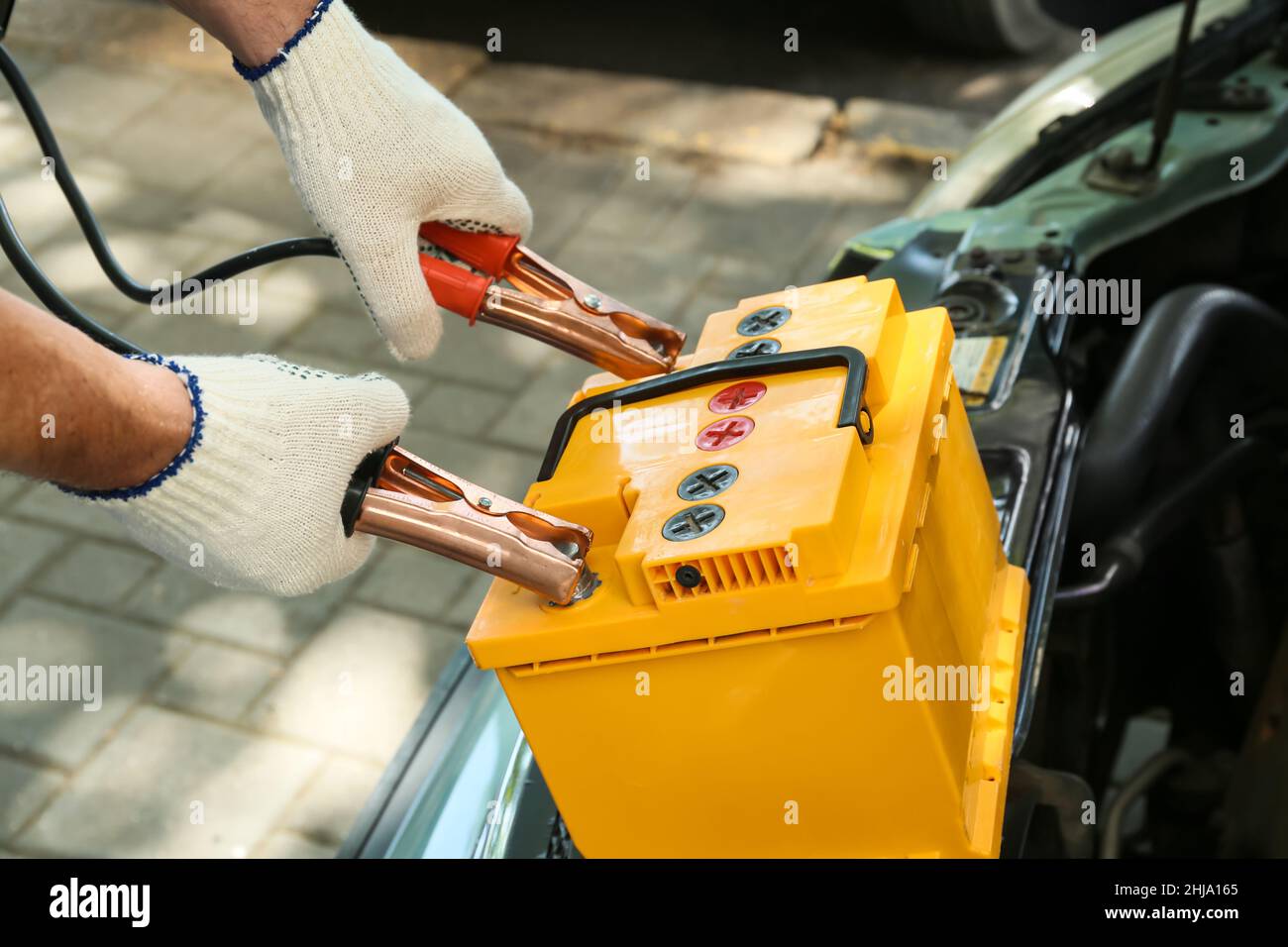 Male mechanic charging car battery Stock Photo Alamy