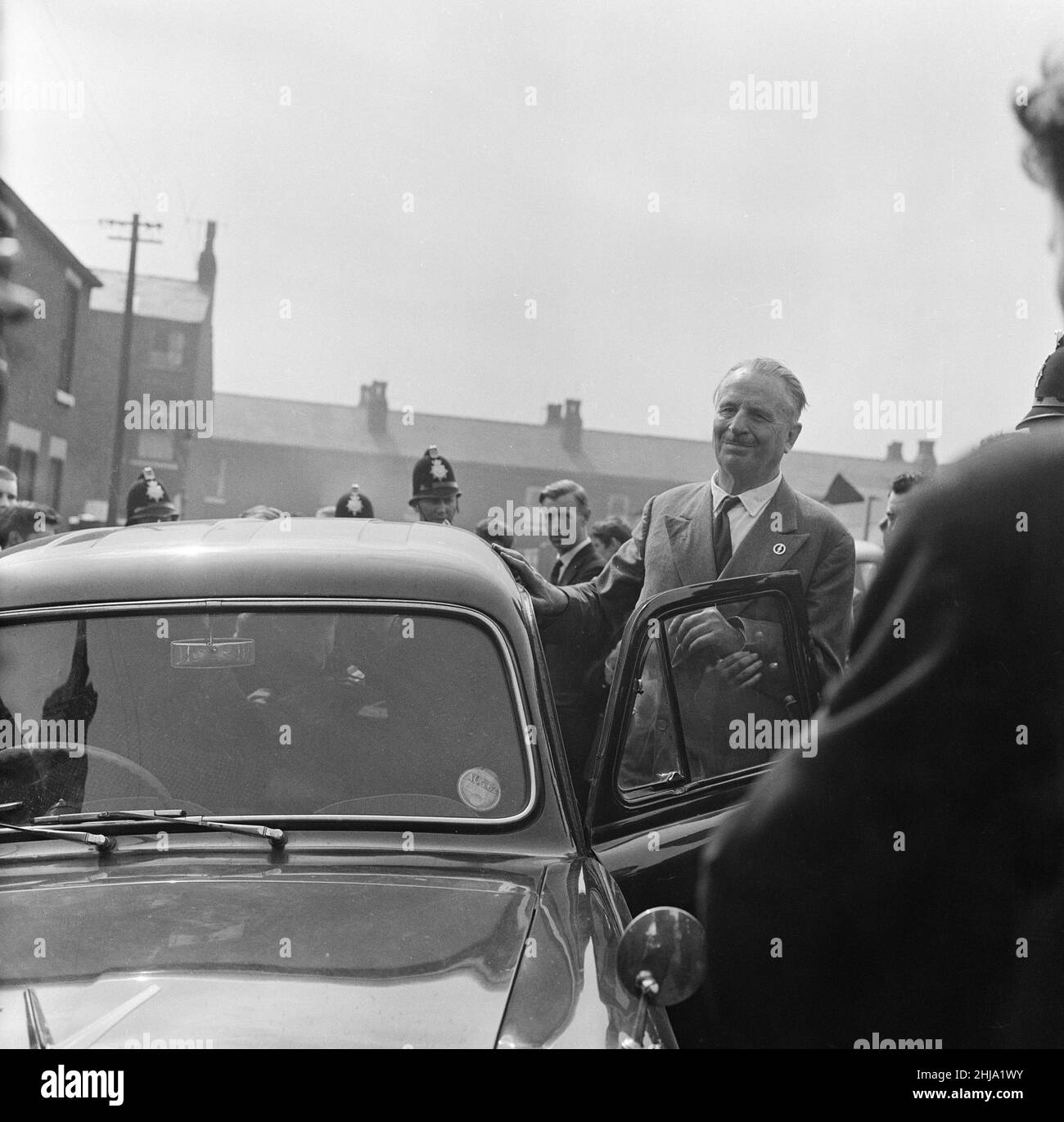 Sir Oswald Mosley visits Manchester to take part in a march organised by his British Union of Fascists supporters, Sunday 29th July 1962. When the eighty marchers gathered, an angry crowd rushed them and Mosley disappeared into a flurry of flying fists and boots and his groups banners were torn to tatters.  Police broke up the fighting mob and rescued 65-year-old Mosley but the march soon turned into a riot causing a mile of terror with fights breaking out every few yards. Many marchers fell out with bleeding faces and torn clothes. The rest were pelted with stones, coins, cabbages, tomatoes a Stock Photo