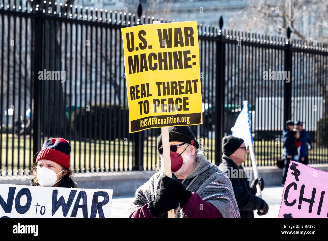 A protester holding a placard saying U.S. war machine: real threat to  peace at a rally against war with Russia sponsored by multiple groups  including CODEPINK: Women for Peace, Black Alliance for